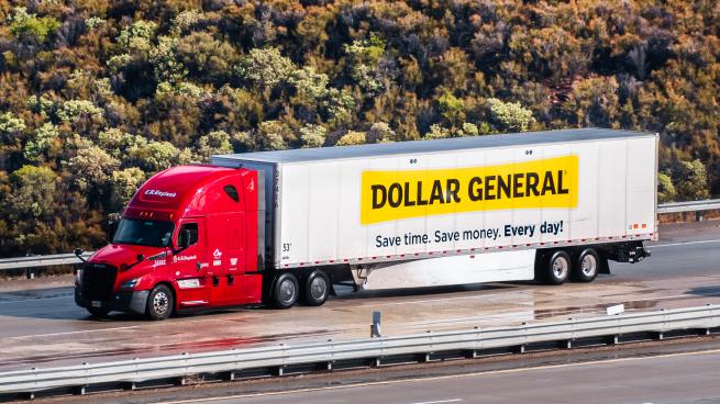 A Dollar General truck on the highway.