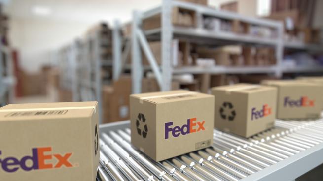 FedEx boxes on a conveyor belt.