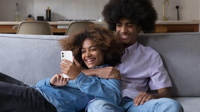 young couple looking at a phone